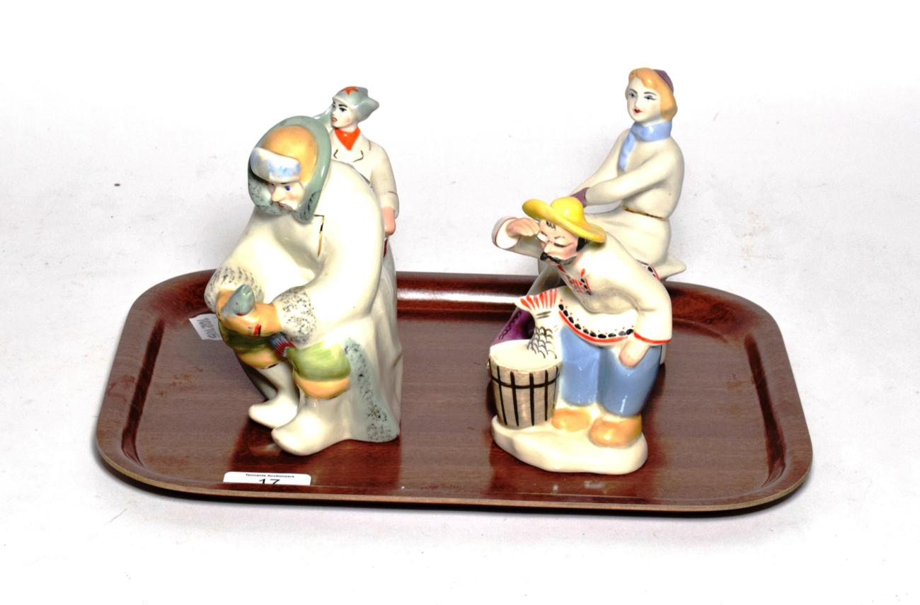 Four 20th century Russian figures including two fishermen, skater and drummer