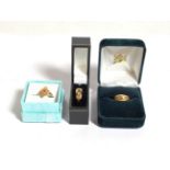 Two 18 carat gold gem set rings, both finger size H; and a gem set ring stamped 750, finger size