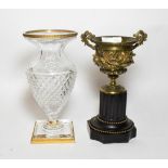 A 19th century French gilt bronze urn on slate socle; and an ormolu mounted cut glass vase