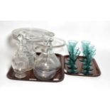 Two tazzas, a port decanter, three other decanters and a set of eight 19th century green glass wines