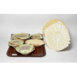 A collection of Belleek comprising five floral decorated baskets and a pair of plates