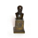 A small bronze bust of a gentleman on a square plinth base