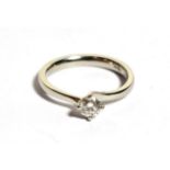 A platinum solitaire diamond ring, a round brilliant cut diamond in a claw setting, to bypass