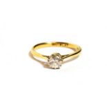 A solitaire diamond ring, a round brilliant cut diamond in a claw setting above an extended under