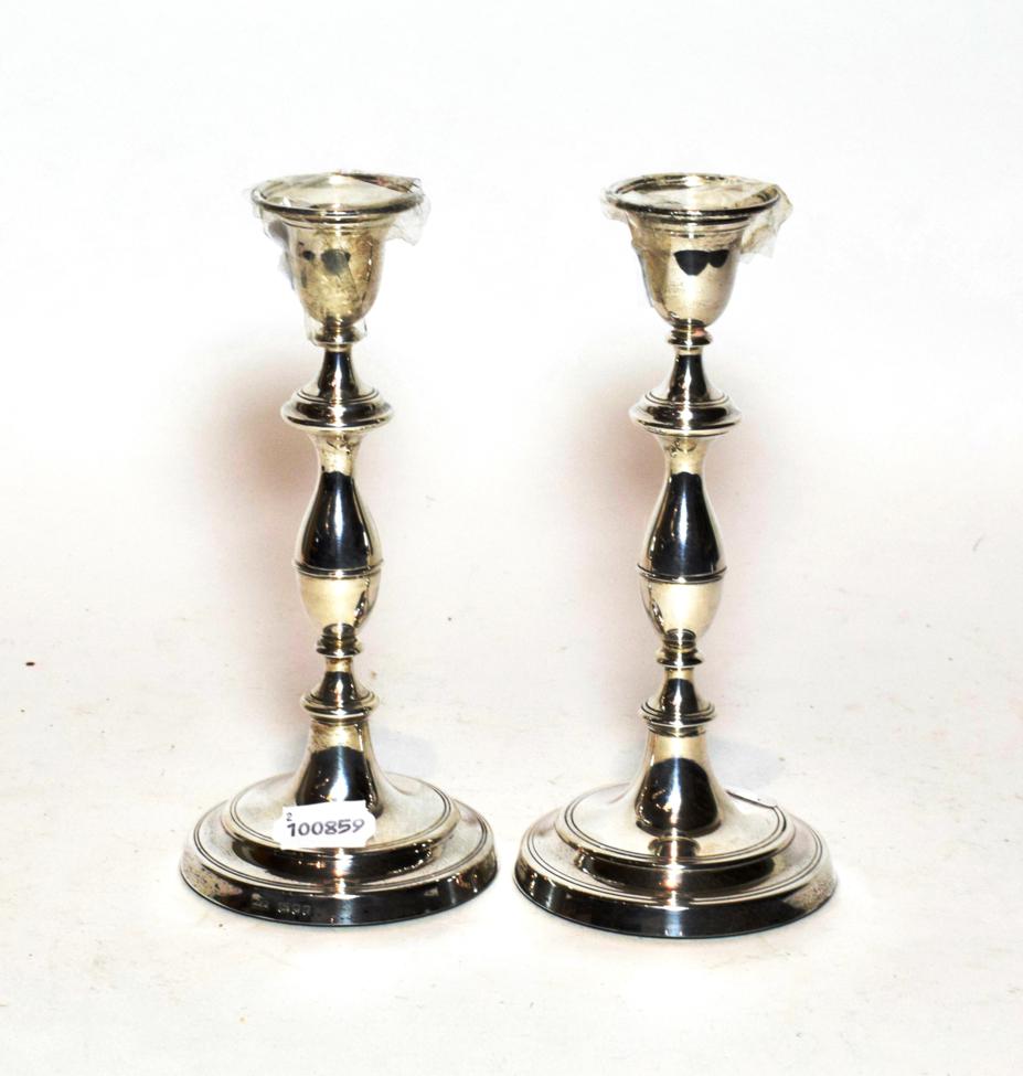 A pair of Georgian style baluster candlesticks, maker's mark W E V, London, 1985, filled (2)