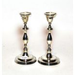 A pair of Georgian style baluster candlesticks, maker's mark W E V, London, 1985, filled (2)