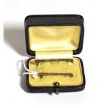 Two bar brooches, lengths 3.1cm and 3.8cm, in a fitted case; and one earring, unmarked . One