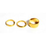 Three 22 carat gold band rings, finger sizes J1/2, J1/2 and M. Gross weight 15.2 grams.