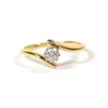 An 18 carat gold diamond solitaire ring, the round brilliant cut diamond in a white claw setting, to