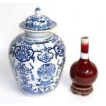A Chinese sang de boeuf bottle vase, together with a Chinese blue and white porcelain baluster