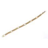 A 9 carat gold rollerball figaro link bracelet, length 18.5cm. The bracelet is in very good