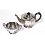 A George V silver teapot, by Viners, Sheffield, 1931, the lower body faceted and on spreading