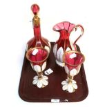 A four piece cranberry and white glass overlay wine set comprising jug, decanter and pair of