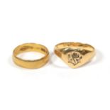 A 22 carat gold band ring, finger size K1/2; and a signet ring, marks rubbed, finger size S1/2 (
