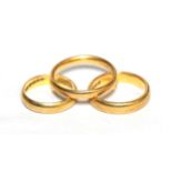 Three 22 carat gold band rings, finger sizes J, K1/2 and Q (3). Gross weight 13.61 grams.