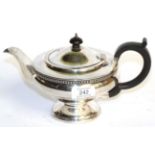 A George V silver teapot, by James Deakin and Sons, Birmingham, 1931, circular and on spreading
