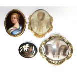 Two oval mourning brooches; a sliver mounted hardstone brooch, and an oval porcelain portrait brooch