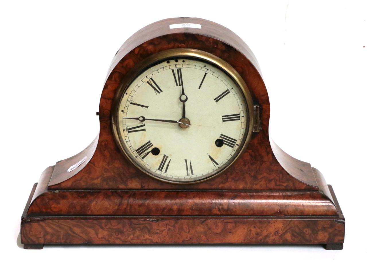 A late Victorian walnut veneered striking mantel clock