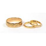 A 9 carat gold band ring, finger size Z; a 22 carat gold band ring, finger size J; and a ring