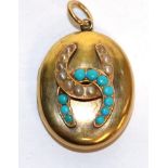 A turquoise and seed pearl horseshoe motif locket, unmarked, measures 3cm by 4.3cm . Gross weight