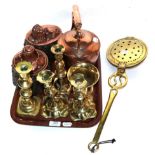 Two 19th century copper jelly moulds, a Victorian copper kettle, two pairs of brass candlesticks,