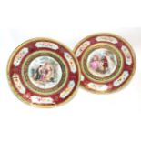 A pair of gilt and floral decorated Vienna plates with central painted Shakespearian scenes