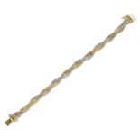 A two colour gold bracelet, clasp stamped '14K' '585', length 19cm. Gross weight 19.8 grams.