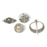 Four Scottish silver brooches, of varying designs, all stamped 'IONA'. Gross weight 28.14 grams.