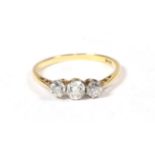 A diamond three stone ring, stamped '18CT', finger size L1/2 . Claws very worn. Gross weight 1.7