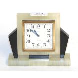 An Asprey Art Deco mantel timepiece 12cm high by 14cm wide. Case with small chips. Surface