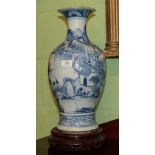 A 19th century Chinese blue and white baluster vase decorated with figures amongst a mountainous