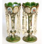 A pair of floral and gilt decorated 19th century green glass table lustresBoth lustres with gilt