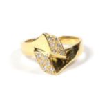 An 18 carat gold diamond cross over ring, finger size L1/2. Gross weight 4.88 grams.