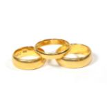 Three 22 carat gold band rings, finger sizes K1/2, Q and R1/2. Gross weight 21.87 grams