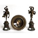 A pair of 19th century bronzes after the antique modelled as musicians; together with an Austrian
