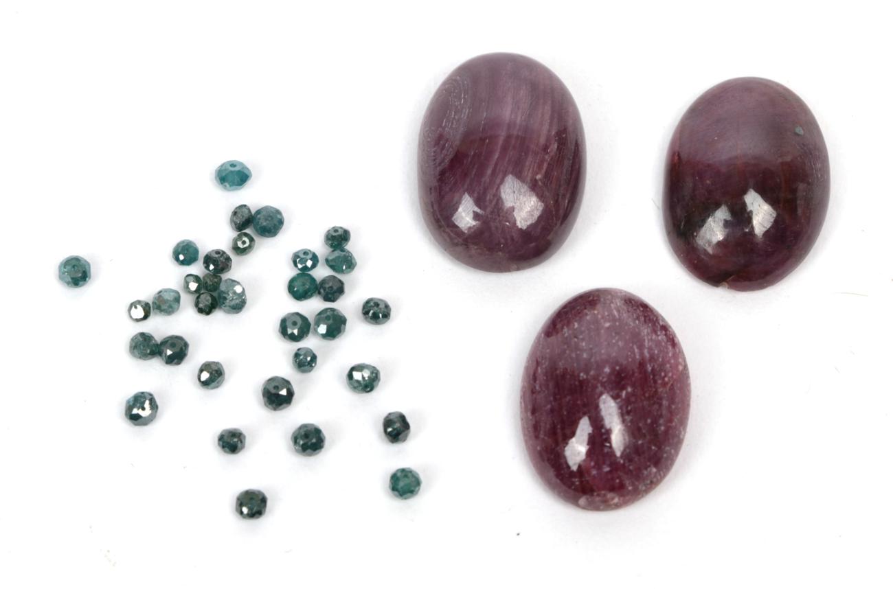 Three loose cabochon ruby type stones; and thirty two loose blue faceted diamonds
