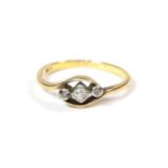 A diamond three stone ring, three round brilliant cut diamonds in white rubbed over settings, on a