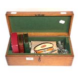 An oak box with a quantity of keys; plated flatware; amber cigar holder; silver napkin ring etc