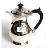 A George V silver hot-water jug, by Wakely and Wheeler, London, 1922, baluster and on collet foot,