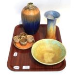Ruskin pottery including trumpet shaped vase, blue ground vase, bowl, egg cups and small dish,