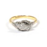 A diamond three stone twist ring, stamped '18CT and PLAT', finger size R . Gross weight 4.17 grams.