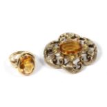 A yellow metal and gemset brooch, unmarked, measures 4.3cm by 3.9cm; and a gemset ring, stamped '