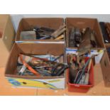 Four boxes containing an assortment of tools including planes, saws, spanners etc