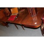 A George III mahogany extending dining tableTop is faded, scratches and small chips. Staining