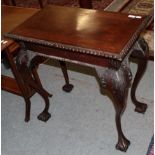 A George III style carved mahogany side table with drawer, on claw and ball feet