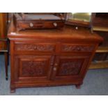 A 20th century Chinese hardwood sideboard, with two drawers above two cupboard doors