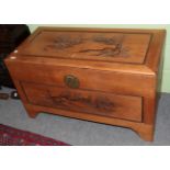 A Chinese camphor wood chest with carved top