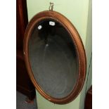 A gilt oval shaped wall mirror