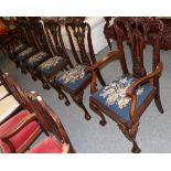 A set of six Chippendale style mahogany dining chairs, with blue floral upholstery (4+2)