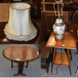 An Edwardian inlaid mahogany occasional table; an oak table with oval folding top; a pottery table